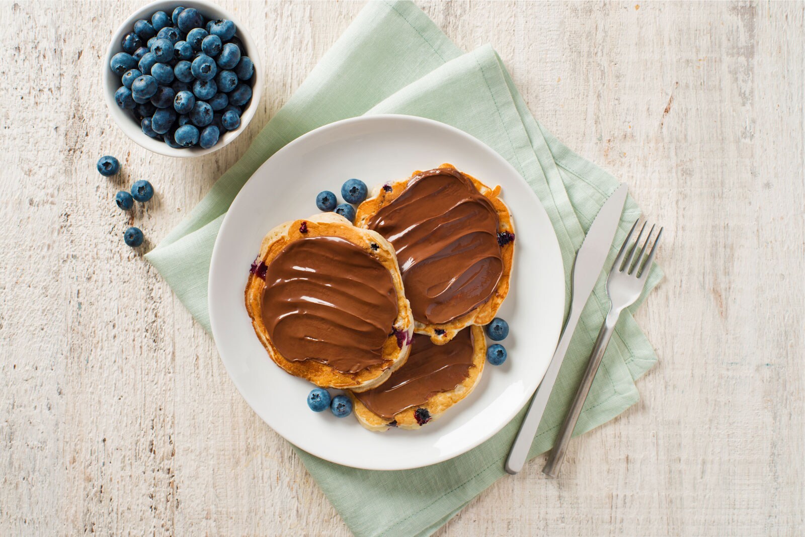 Mini blueberry buttermilk pancakes with Nutella® and strawberries